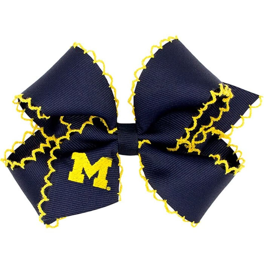 Navy blue hair bow with yellow trim and 'M' logo on a white background