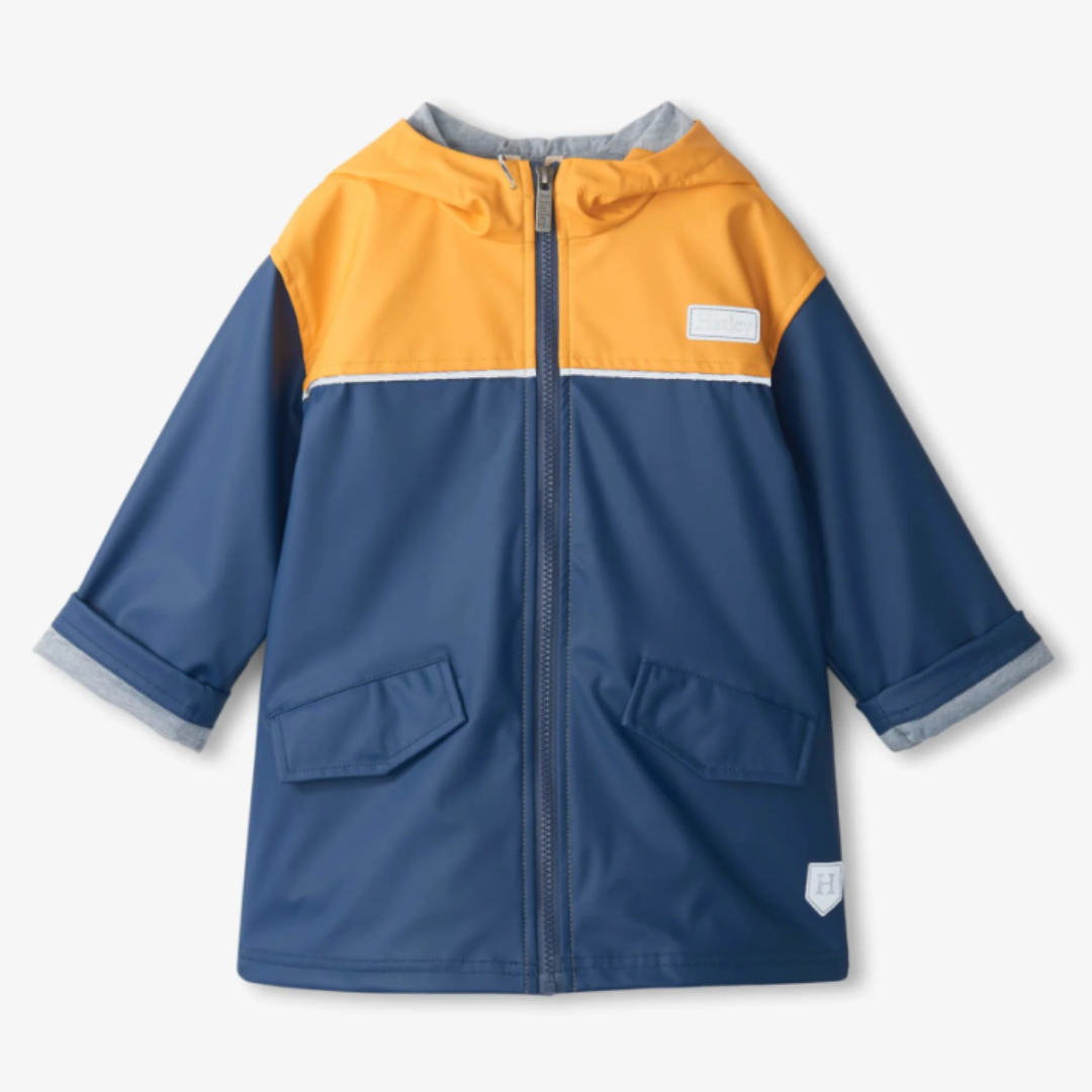 Children's raincoat with orange and blue color block design on a white background