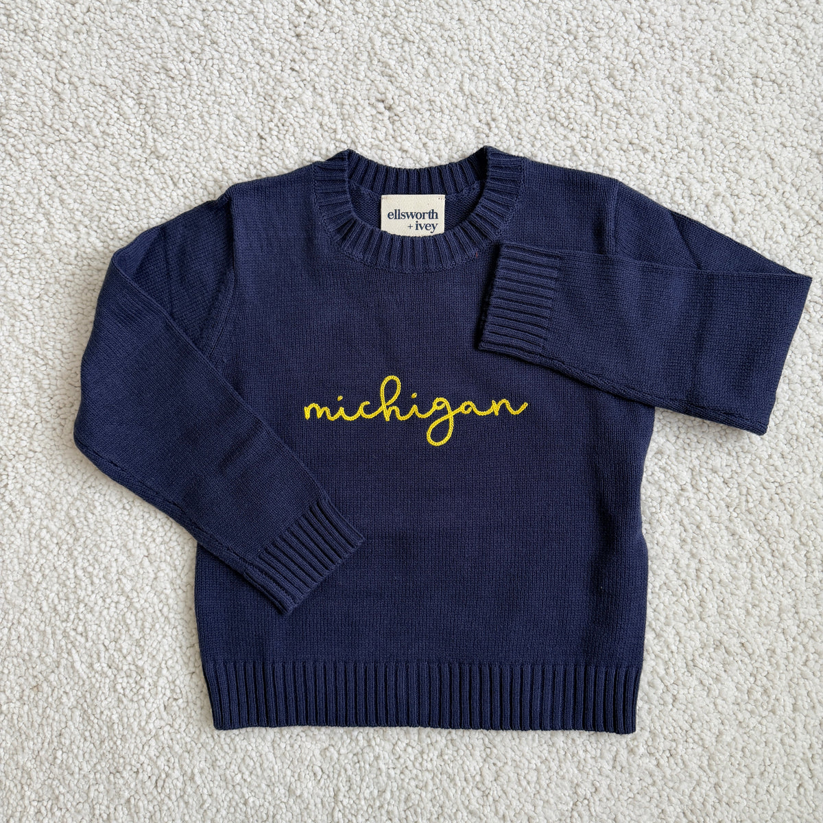 Premium Navy knit cotton blue sweater with 'Michigan' in maize cursive text 