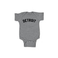 Gray baby onesie with 'DETROIT' printed on it against a white background