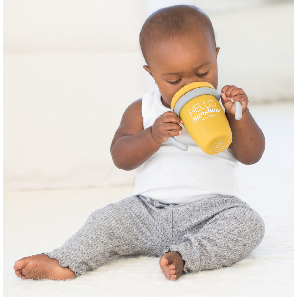 boy using yellow sippy cup