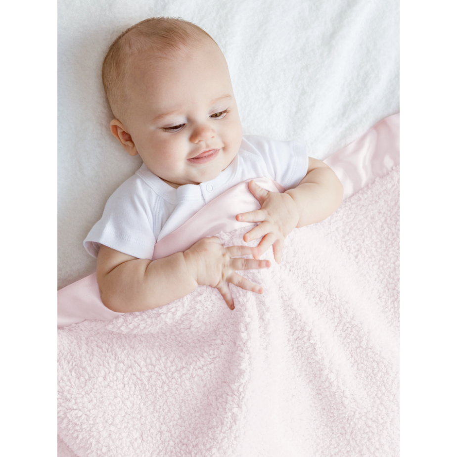 baby under pink blanket