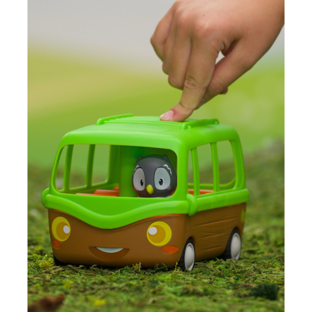 green adventure bus with small animal driving